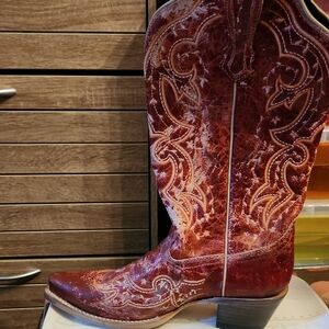 Red Heeled Boots with Intricate Stitching and Classic Silhouette